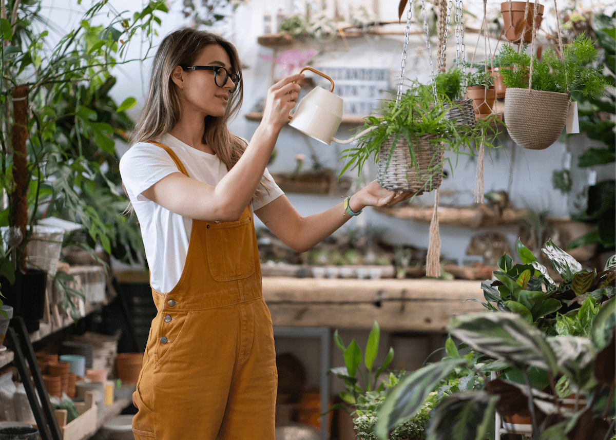 woman watering houseplants